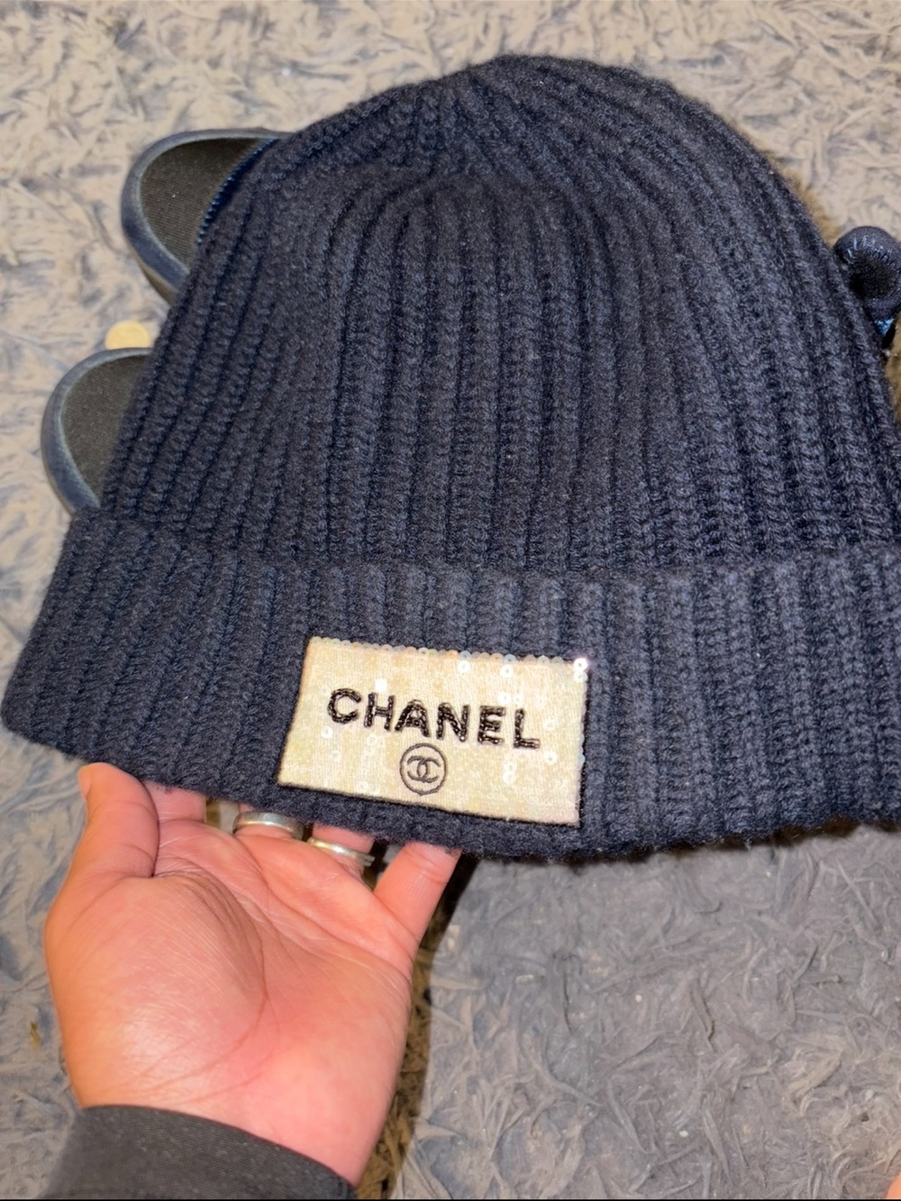 CHANEL Black Ribbed Knit Beanie with Embellished Logo Patch
